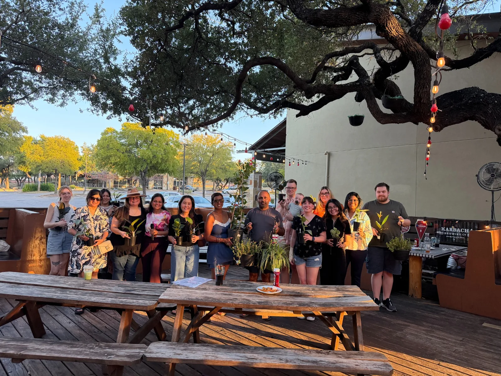 Guests with plant prizes at a Green Gathering Club Plant Bingo event in Austin